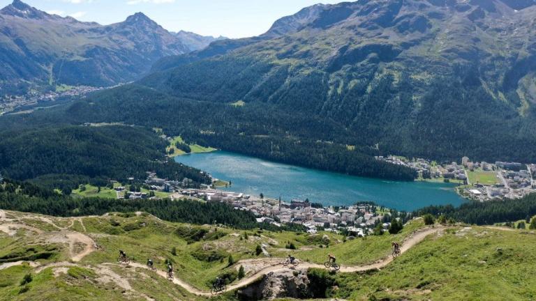 High shot photo of swiss countryside with some bikers on a pass below [Epic Series}