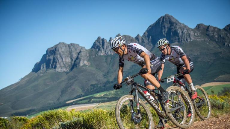 Käss and Geismayr biking through a rocky path [Swiss Epic]