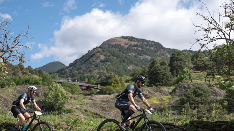 A shot of two bikers with an Andorran background [Andorra MTB Classic-Pyrenees]