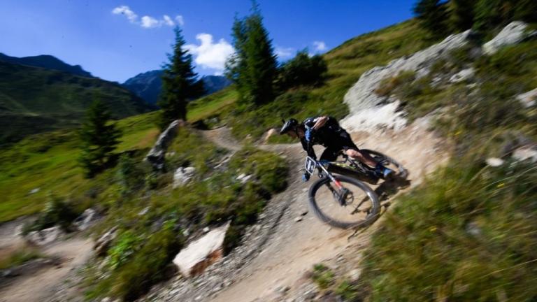 e-bikes on the Swiss Epic Team taking a steep bank [Swiss Epic]
