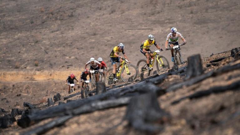 Multiple bikers heading up a rocky terrain [Absa Cape Epic]