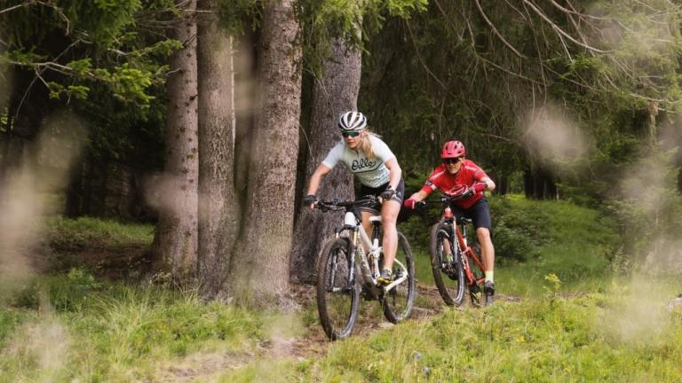 Ariella Kaeslin biking through a forest [Swiss Epic]