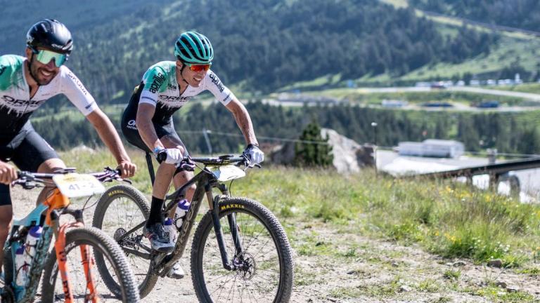 Two bikers heading across a Pyrenees landscape [Andorra MTB Classic-Pyrenees]