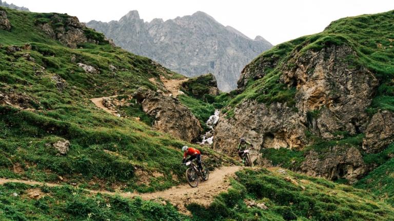 The San Marco team heading down a narrow mountain path [Swiss Epic]