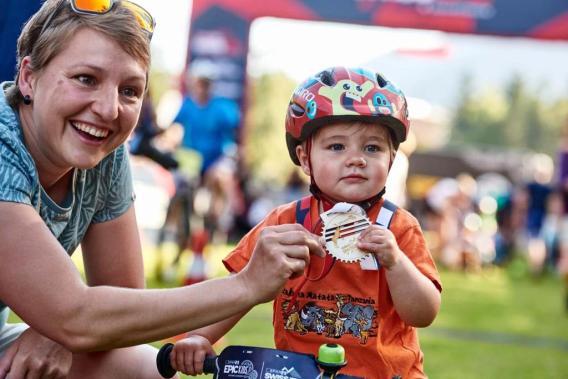 A child with his mother at the finish line of Epic Kids with the finisher medal