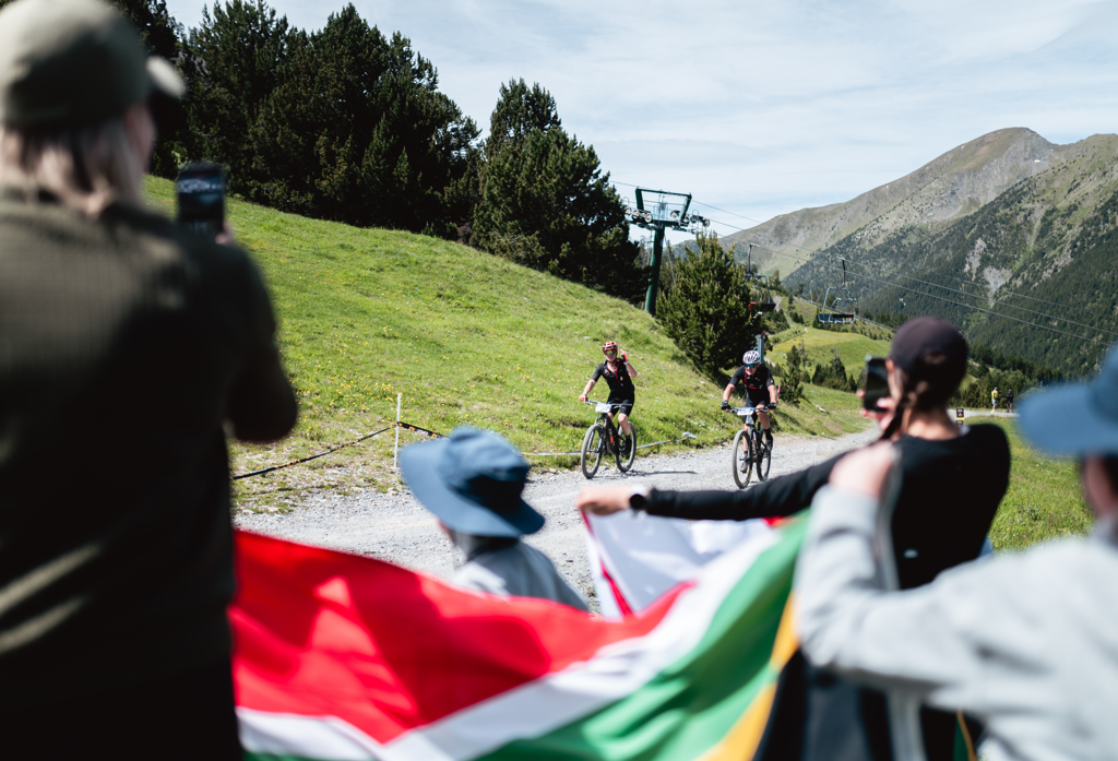 Supporters with flags cheering on riders at Swiss Epic