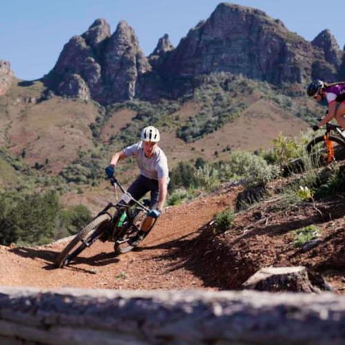 a biker taking a steep dirt turn [FNB Wines2Whales]