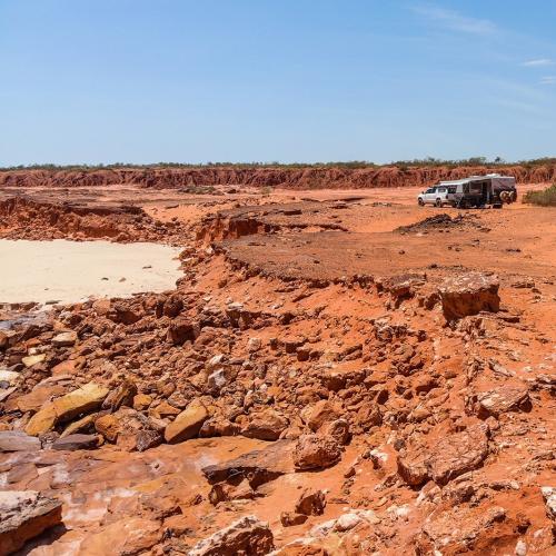 Lehmann and Anson-Smith posing on some dark red clay roads [Cape to Cape]