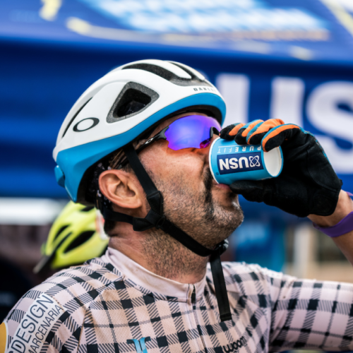 Someone drinking a small cup of USN [FNB Wines2Whales]