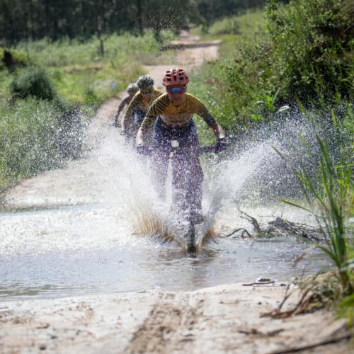 Adelheid Morath, from team Faces, splashes through one of the puddles left on the route after the previous day’s downpour. Image by Xavier Briel [FNB Wines2Whales]