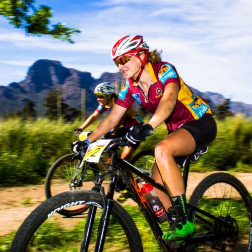 Two bikers racing against a mountain backdrop [FNB Wines2Whales]
