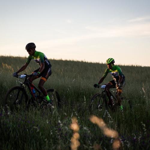 Two bikers heading through a field [FNB Wines2Whales]
