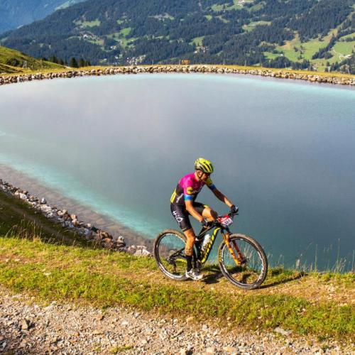 The Pyrenees race with a beautiful lake in the background [Andorra MTB Classic-Pyrenees]