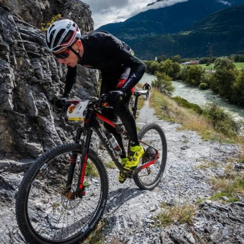 One biker struggling up a sharp incline [Swiss Epic]