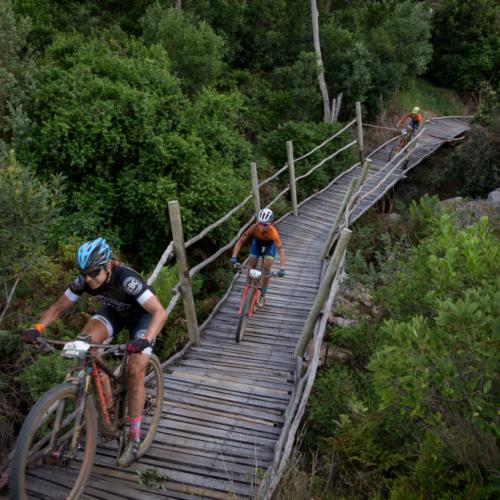 Bikers heading over a bridge made of wood [FNB Wines2Whales]