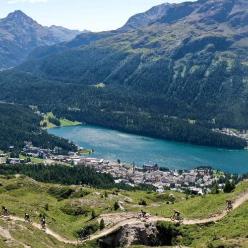 High shot photo of swiss countryside with some bikers on a pass below [Epic Series}
