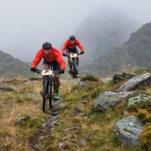 Käss and Geismayr biking through a rocky path [Swiss Epic]