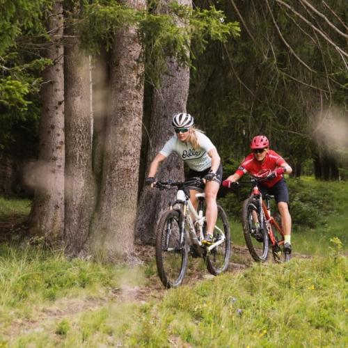 Ariella Kaeslin biking through a forest [Swiss Epic]