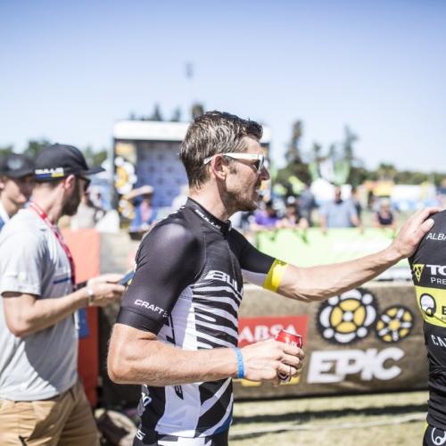 A biker putting his hand on Alban Lakata's shoulder [Absa Cape Epic]