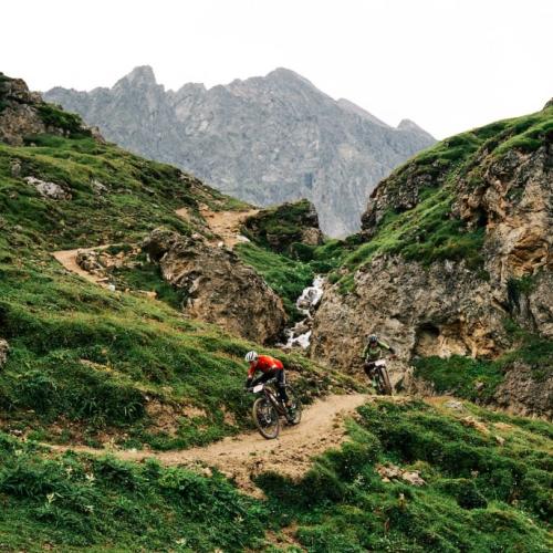 The San Marco team heading down a narrow mountain path [Swiss Epic]